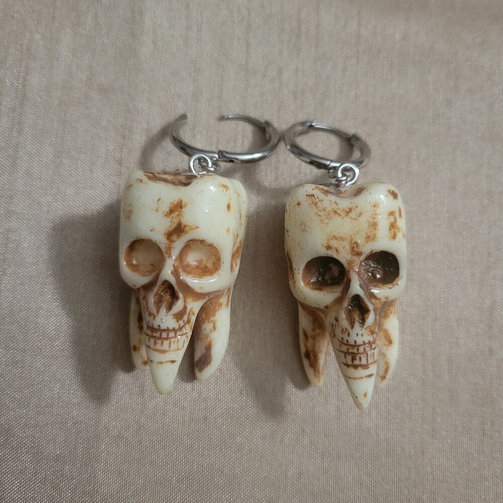 Creepy distressed teeth with skull faces earrings